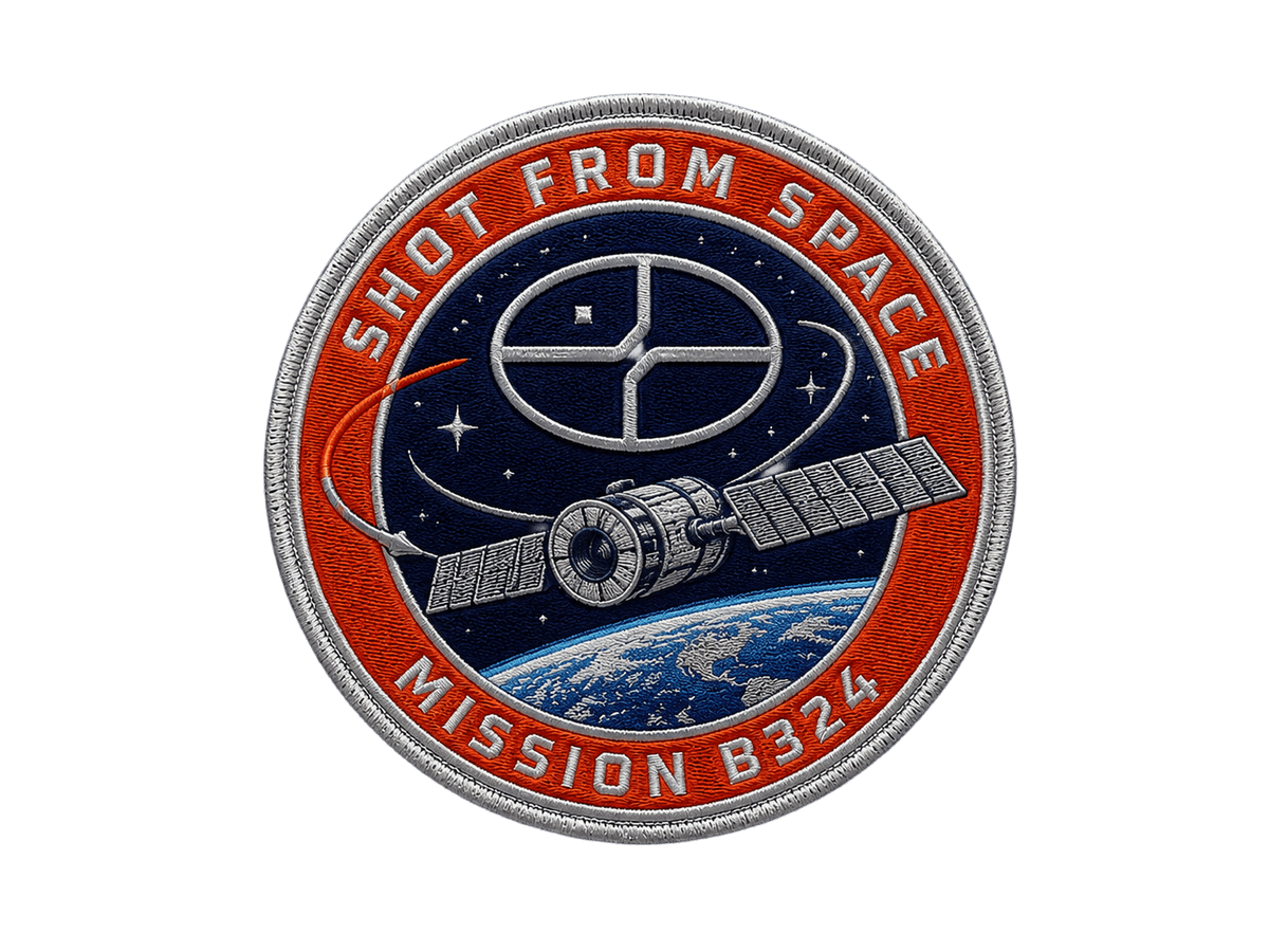 A render of an embroidered mission patch, square on, its stitched edge catching the light.